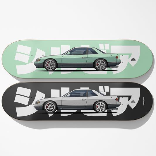 Two skateboard decks with car illustrations on a white background