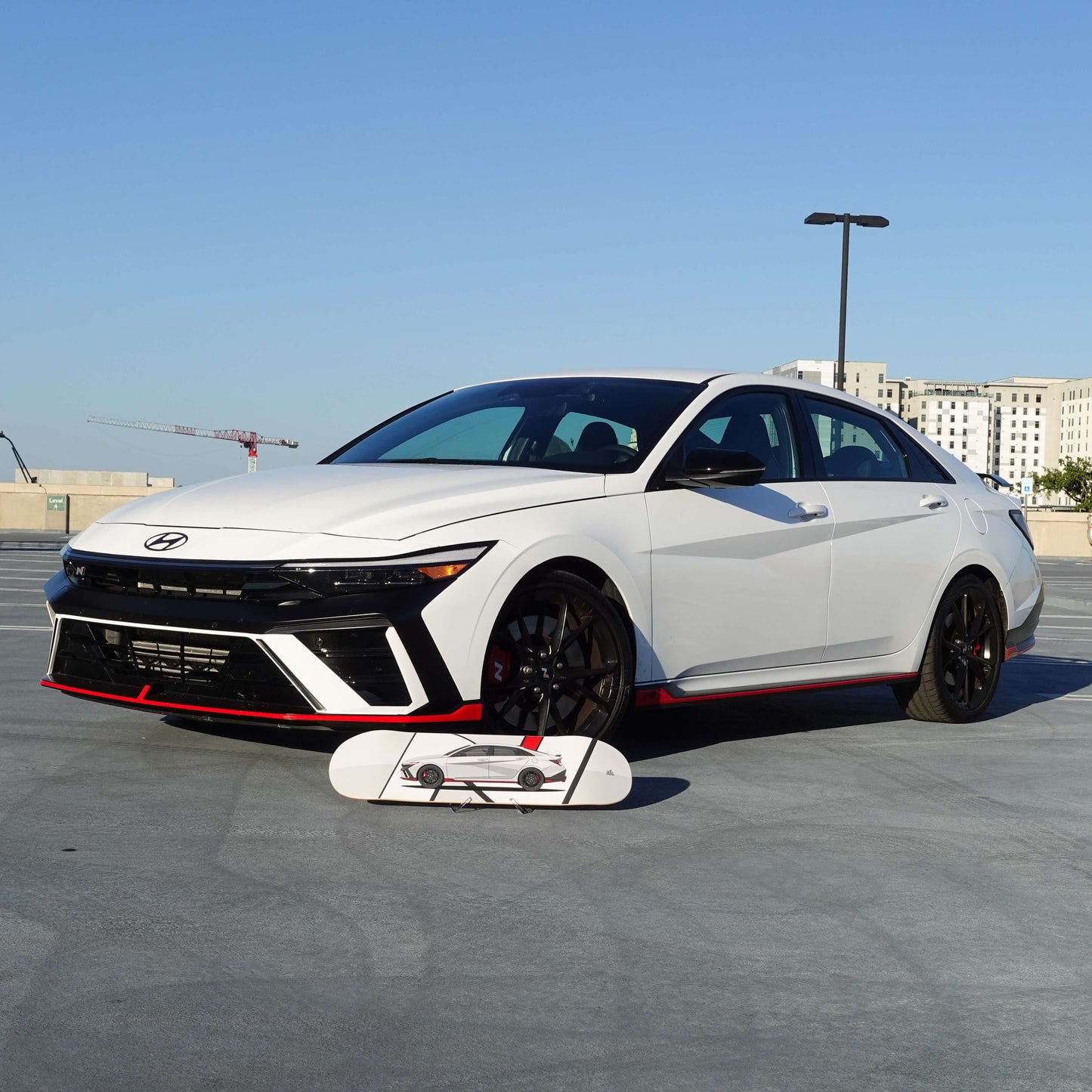 White Hyundai car on a concrete surface with a clear blue sky in the background