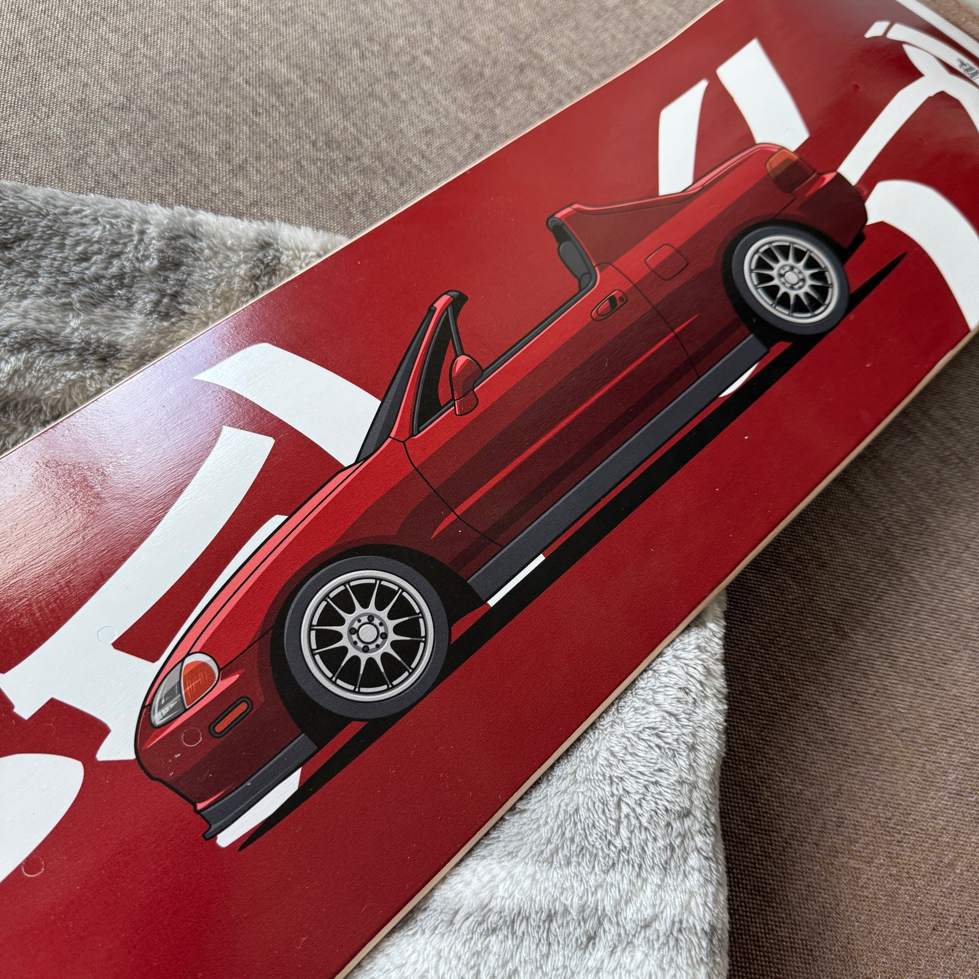 Red car design on a skateboard deck 