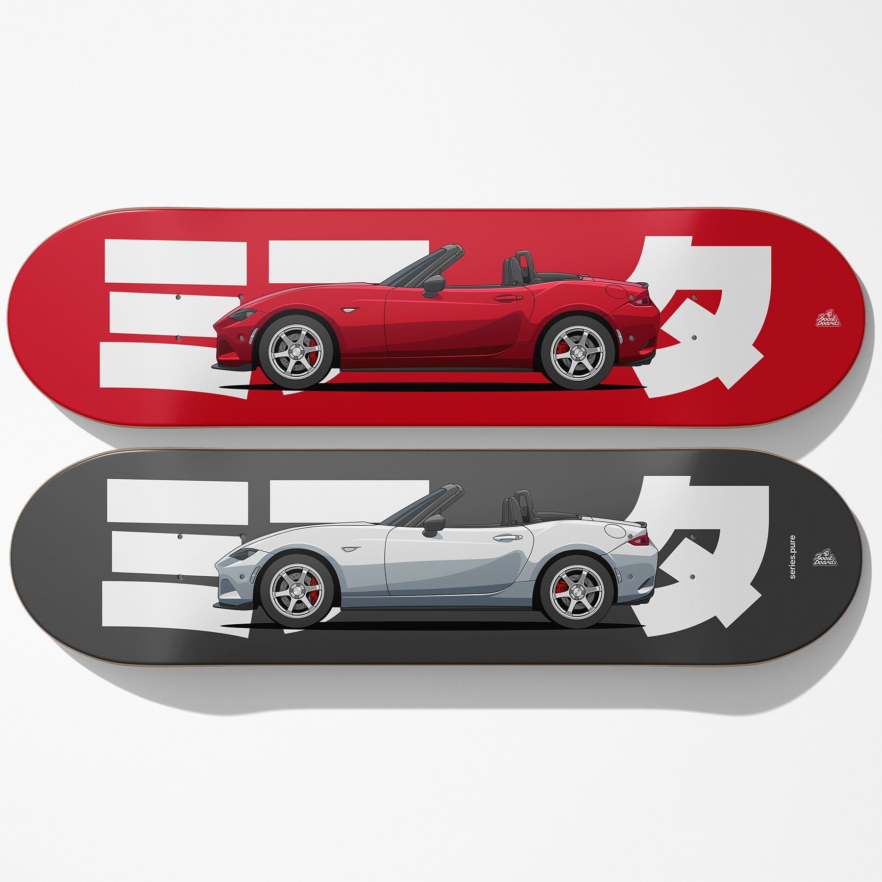 Two skateboard decks with red and white car design on a red deck and gray and white car design on a gray deck.